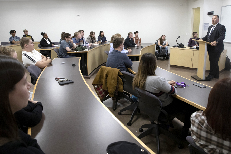 A judge speaks to a class in Hyland Hall.